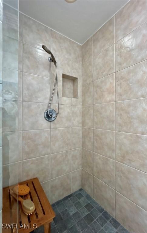 bathroom with a tile shower