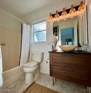 full bathroom with tile patterned flooring, shower / bath combo, vanity, and toilet