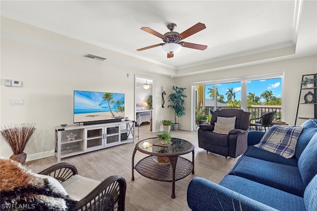 living room featuring ceiling fan, light hardwood / wood-style floors, and ornamental molding