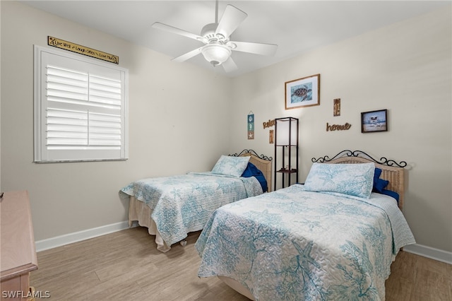 bedroom with ceiling fan and light hardwood / wood-style floors