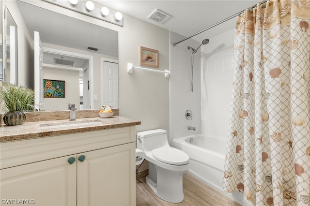 full bathroom featuring hardwood / wood-style floors, vanity, toilet, and shower / tub combo with curtain