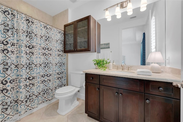 bathroom with toilet, tile patterned floors, and vanity