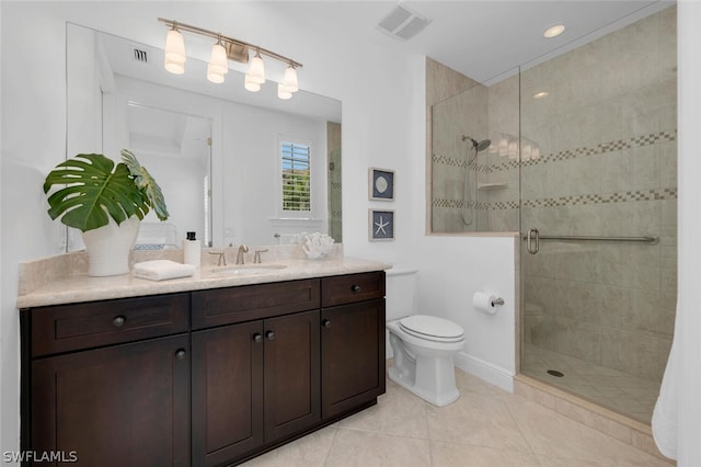 bathroom with vanity, toilet, tile patterned floors, and walk in shower