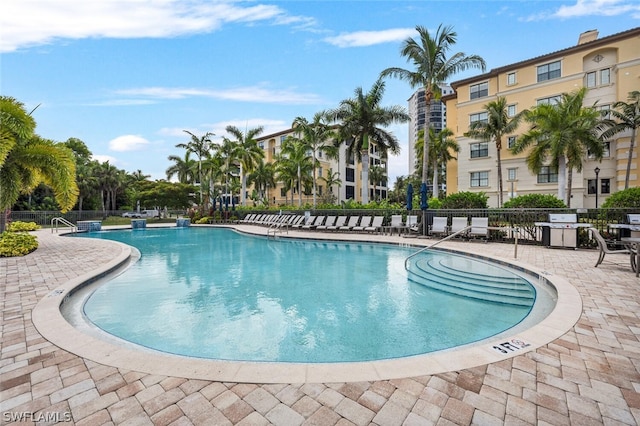 view of pool with grilling area and a patio area