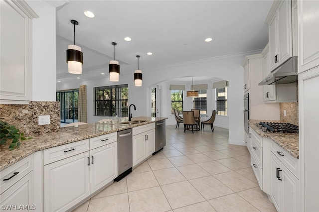 kitchen with decorative light fixtures, decorative backsplash, appliances with stainless steel finishes, and white cabinetry