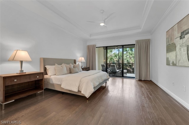 bedroom featuring ceiling fan, a raised ceiling, dark wood-type flooring, access to exterior, and ornamental molding