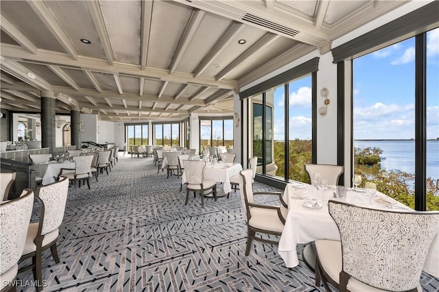 sunroom / solarium featuring a water view and coffered ceiling