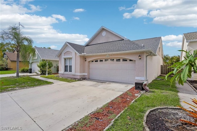 single story home with a front yard and a garage