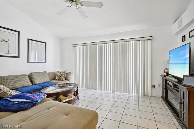 living room featuring light tile patterned floors, vaulted ceiling, and ceiling fan