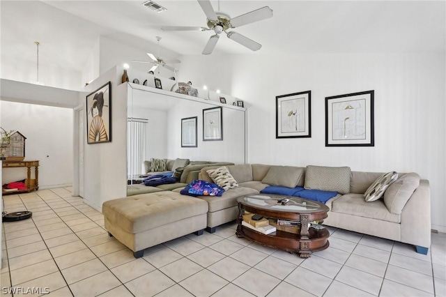 living room with light tile patterned floors and high vaulted ceiling