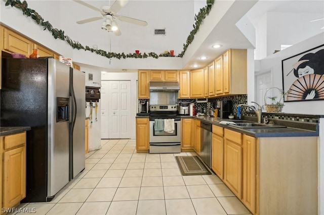 kitchen with ceiling fan, sink, light tile patterned floors, and stainless steel appliances