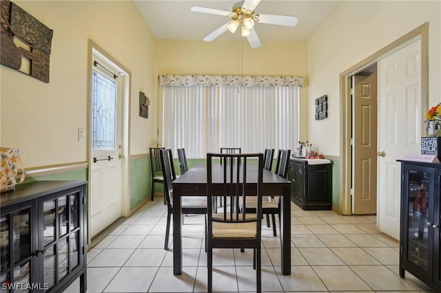 dining room featuring ceiling fan, light tile patterned floors, and beverage cooler