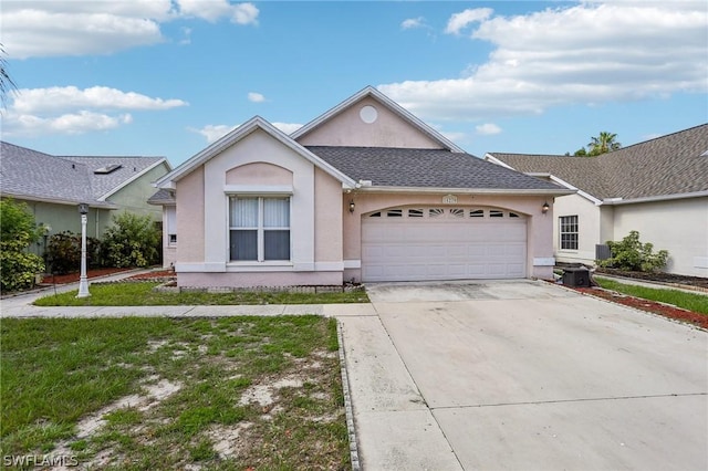 ranch-style home featuring a garage and a front lawn