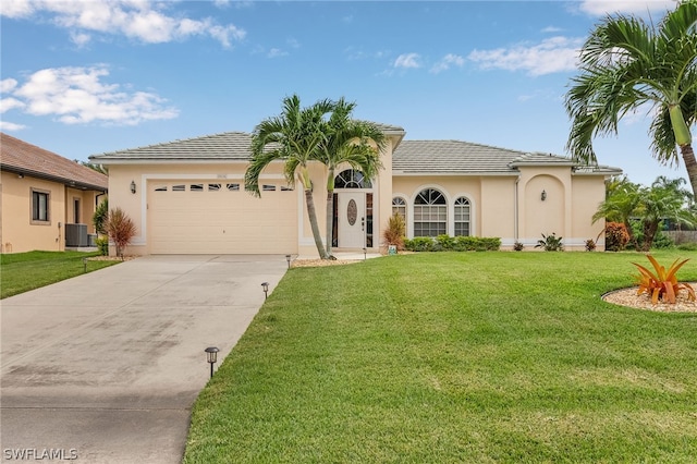 view of front of house featuring a garage, a front yard, and central AC unit