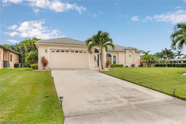 view of front of property with a garage, central air condition unit, and a front lawn