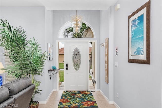 tiled foyer entrance with a chandelier