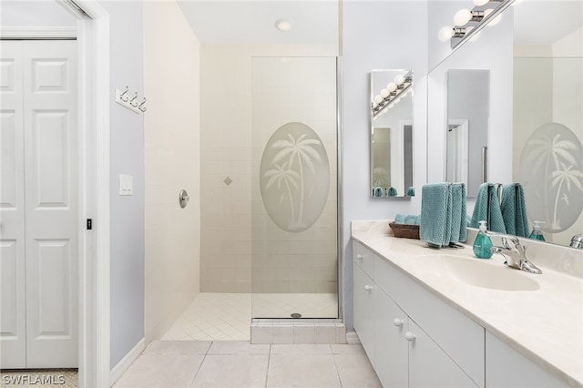 bathroom with tile floors, vanity with extensive cabinet space, and tiled shower