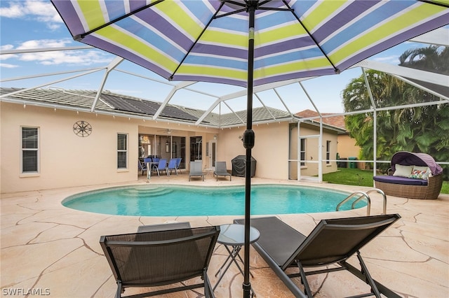 view of pool with a lanai and a patio area