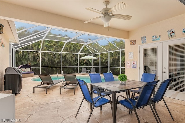 sunroom featuring ceiling fan and french doors