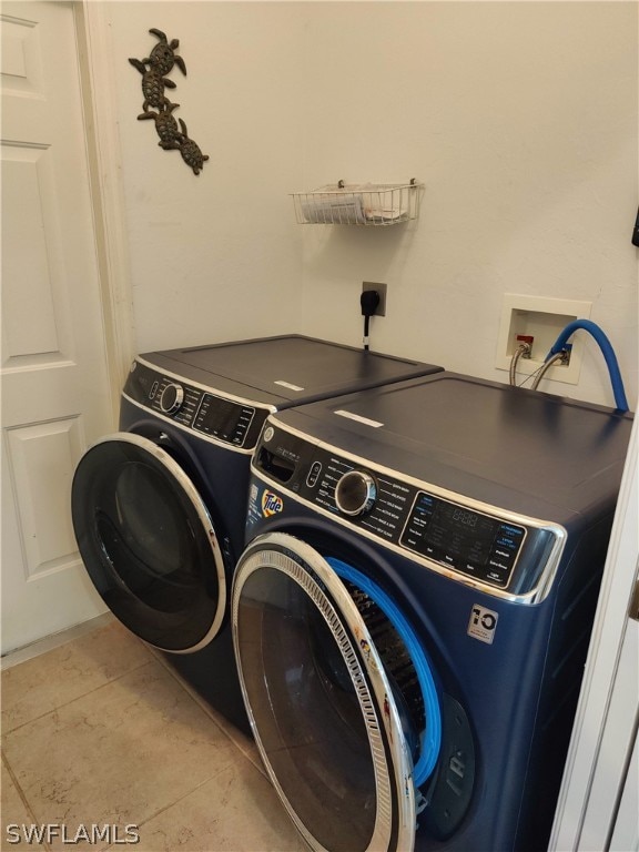 washroom featuring tile floors, washer hookup, electric dryer hookup, and washing machine and dryer