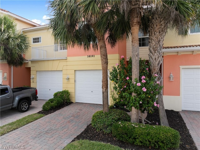 view of front of house with a garage and a balcony