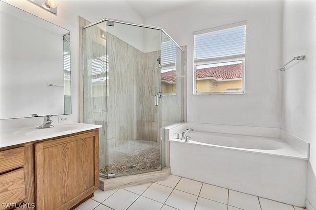 bathroom featuring tile patterned floors, shower with separate bathtub, and vanity