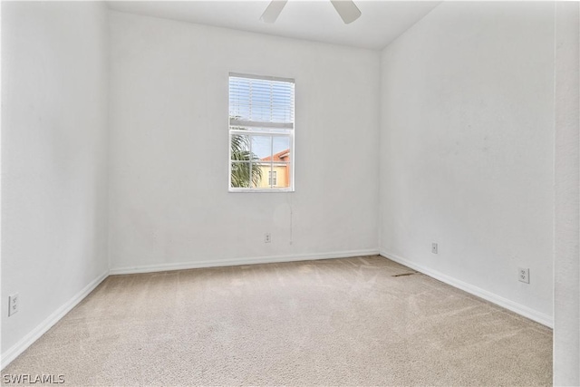 carpeted spare room with ceiling fan