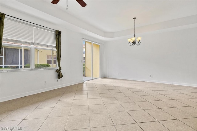 tiled empty room with ceiling fan with notable chandelier