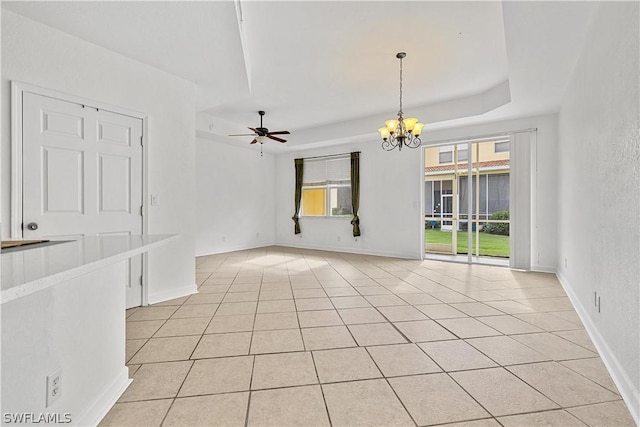 unfurnished living room featuring ceiling fan with notable chandelier and light tile patterned flooring