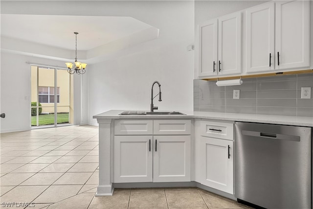 kitchen with dishwasher, hanging light fixtures, white cabinets, and backsplash