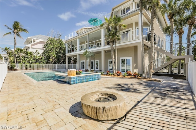 view of swimming pool featuring a patio and an outdoor fire pit