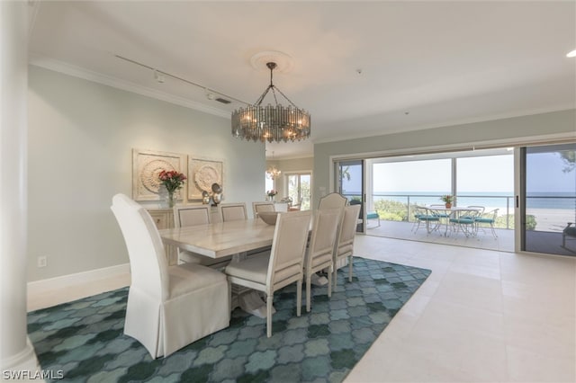 tiled dining room with track lighting, a water view, crown molding, and a chandelier