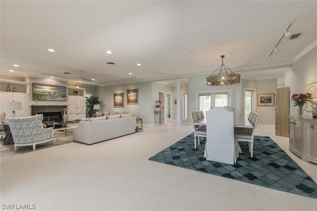 dining area featuring carpet, a chandelier, and ornamental molding