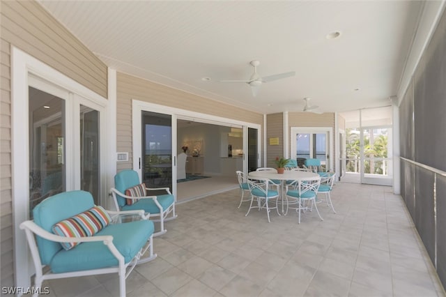 sunroom featuring ceiling fan