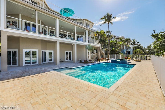 view of swimming pool with an in ground hot tub and a patio