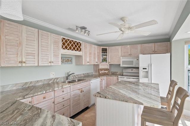 kitchen with a center island, white appliances, a kitchen breakfast bar, crown molding, and sink