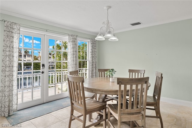 dining area featuring french doors, light tile patterned floors, and ornamental molding