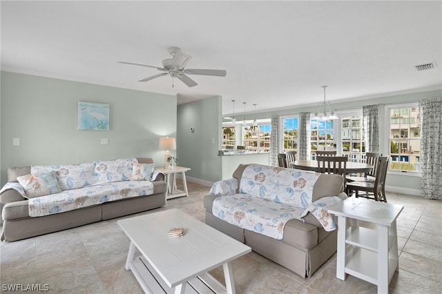 living room with ceiling fan with notable chandelier and crown molding