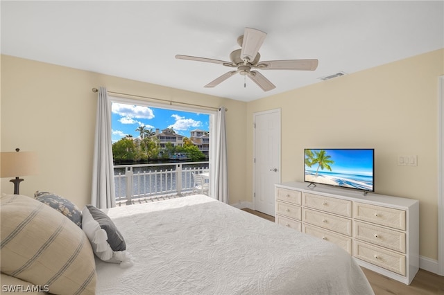 bedroom featuring access to exterior, ceiling fan, and light wood-type flooring