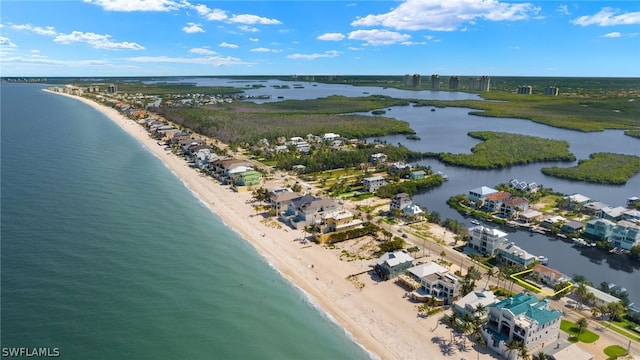 drone / aerial view with a water view and a beach view