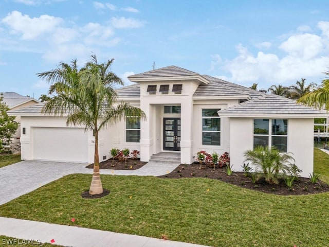 view of front of house featuring a front lawn and a garage