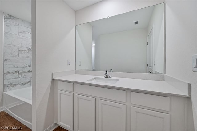 bathroom with shower / bathing tub combination, hardwood / wood-style floors, and vanity