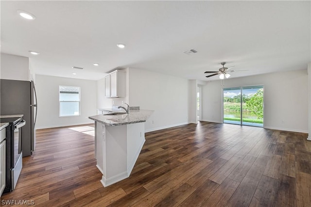 kitchen featuring stainless steel range with electric stovetop, dark wood-type flooring, ceiling fan, light stone countertops, and white cabinetry