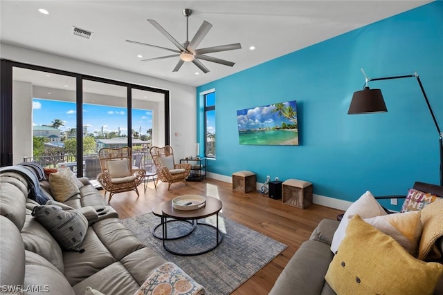 living room with hardwood / wood-style flooring and ceiling fan
