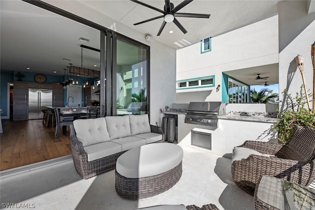 view of patio / terrace featuring an outdoor kitchen, area for grilling, sink, and ceiling fan