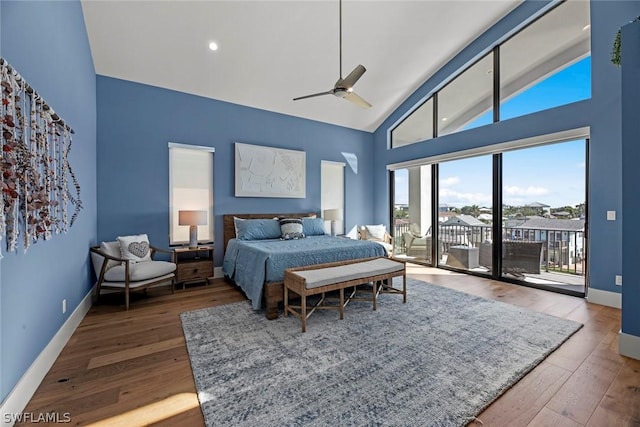 bedroom with ceiling fan, high vaulted ceiling, access to exterior, and hardwood / wood-style floors