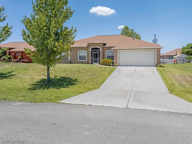 view of front of home featuring a front yard, driveway, an attached garage, and stucco siding