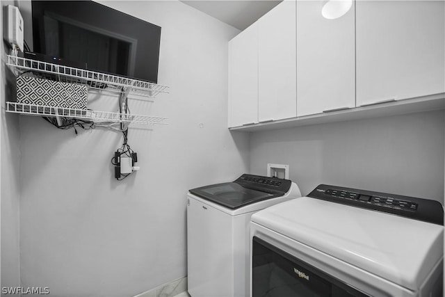 laundry area featuring cabinets and washing machine and dryer