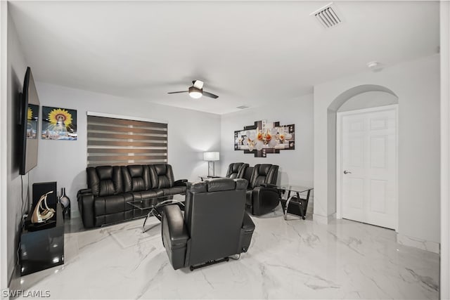 tiled living room with ceiling fan