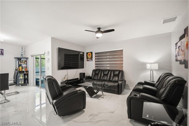 living room featuring ceiling fan and light tile flooring